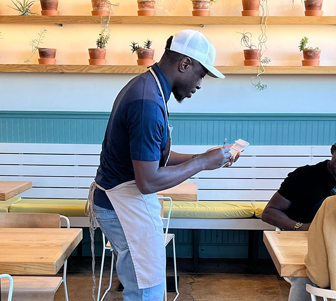 Richard Olaniyi takes an order during the BNSF volunteer day at Taste. 