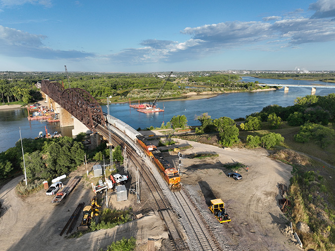 A grain train moves over the new bridge. A grain train moves over the new bridge.